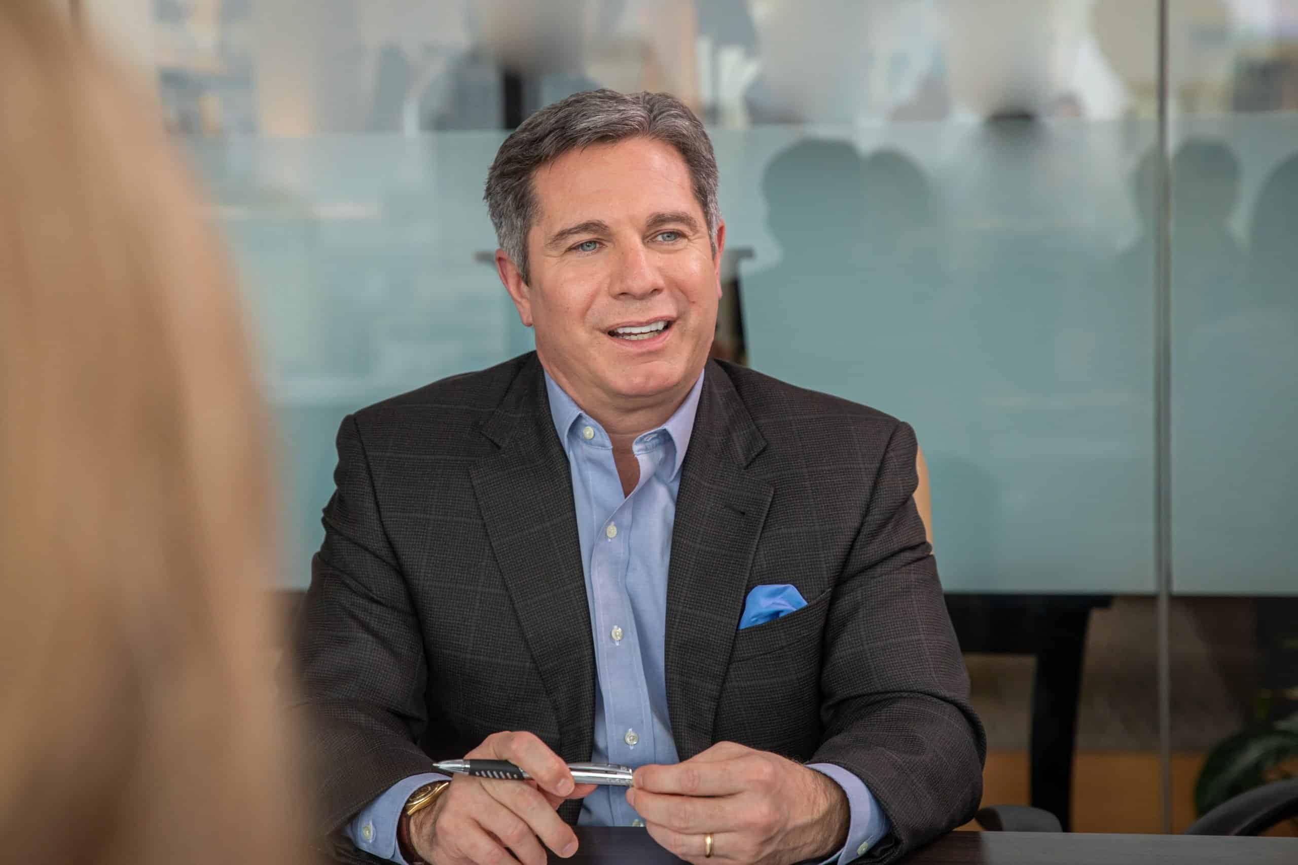 Kevin smiling at conference table
