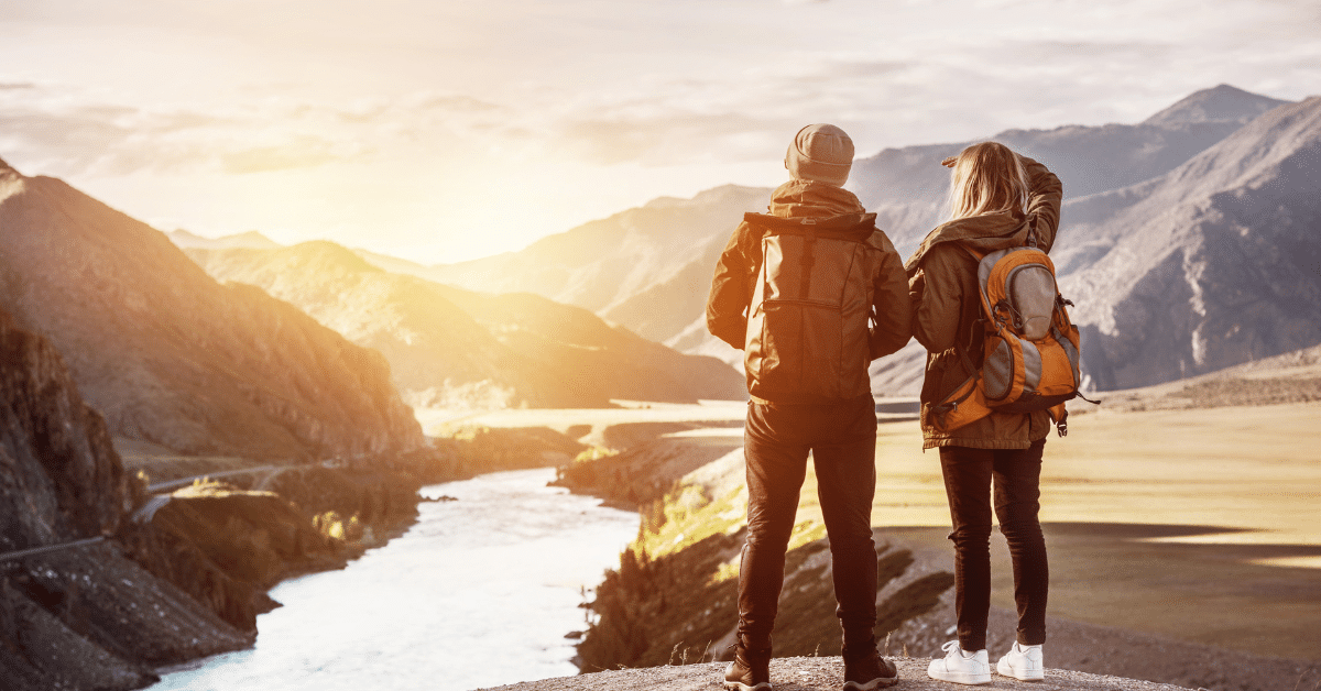 Couple hiking Couple hiking overlooking valley and river
